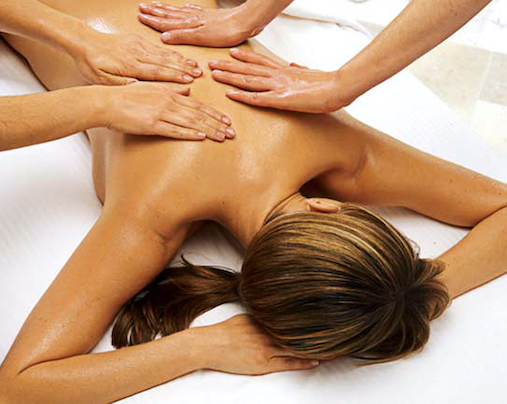 Four handed massage for a woman